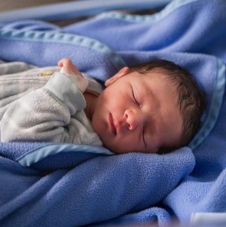 Baby sleeping in a blue blanket